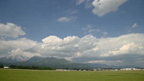 Time lapse of white puffy clouds forming over international Airport Stock Footage 161243214