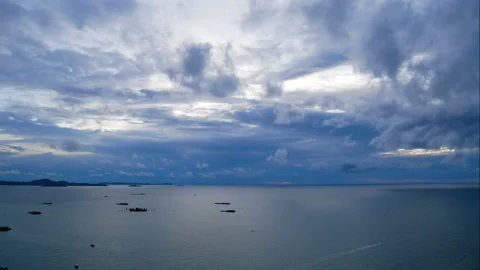 Time lapse of white puffy fluffy clouds fast moving blue sky with golden light Stock Footage 134313480