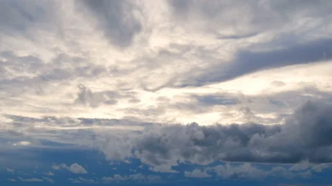Time lapse of white puffy fluffy clouds fast moving blue sky Stock Footage 134335439