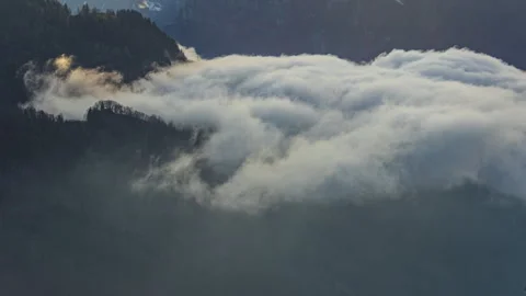 Time lapse, white smoky clouds sweeps the mountains. Smoky clouds or fog ro.. Video stock 264976228