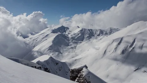 Time lapse of wickedly intense clouds roiling and flowing over peaks. Zoom in Stock Footage 83691353