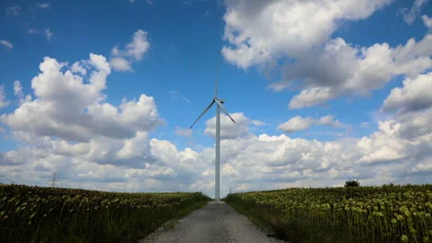 Time lapse of wind turbine white fluffy  clouds Stock Footage 137718219