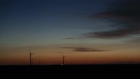 Time lapse of wind turbines on a farm before sunrise Stock Footage 134500067