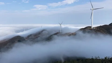 Time-lapse of Wind Turbines Rotating Above a Sea of Clouds on Mountain Ridge Stock Footage 330142147