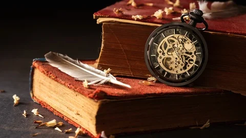 Time lapse winding pocket watch on old books with feathers. Stock Footage 103783909