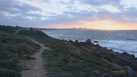 Time lapse on a windy day of a path on a mediterranean  coast at sunset  Stock Footage 104035956