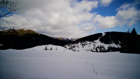 Time lapse of winter clouds and mountains. The rapid movement of clouds that Video stock 117975743