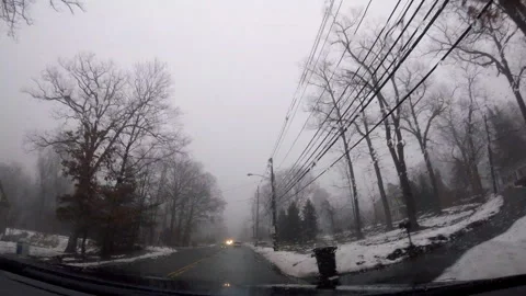 Time lapse of winter drive with snow, fog and rain in suburban town in February Stock Footage 330181374