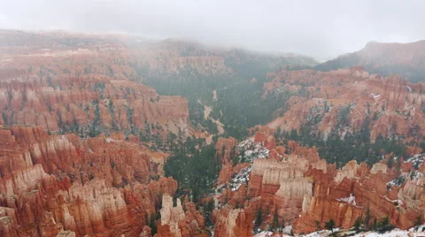 A Time Lapse Of Winter Fog going over A Rocky Snow-Capped Canyon. Stock Footage 51752381