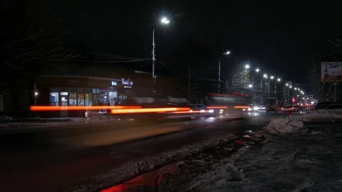 Time lapse of the winter night road in the city. Dirty roadside snow. Stock Footage 83078336