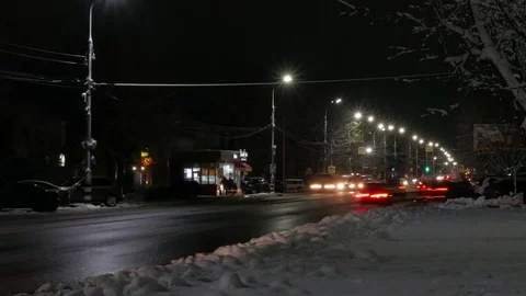 Time lapse of the winter night road in the city. Dirty roadside snow. Stock Footage 83078347