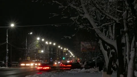Time lapse of the winter night road in the city. Dirty roadside snow. Stock Footage 83078415