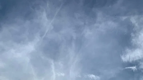 Time lapse of wispy cirrus cloud currents moving in opposing directions Stock Footage 118285618