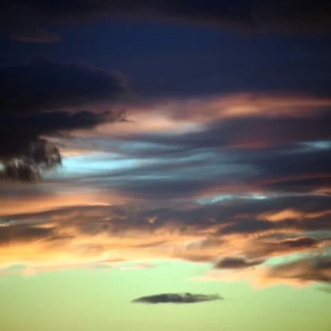 Time-lapse of wispy clouds changing color at sunset Stock Footage 69443773