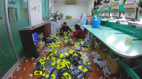Time-lapse of A worker hand folding T-shirt in garment manufacture Stock Footage 112077259