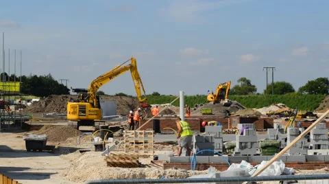Time lapse workers using mechanical diggers building new houses United Kingdom Stock Footage 66534380