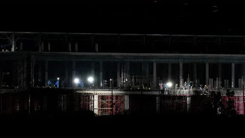 Time lapse of workers working at the large construction site at night. Stock Footage 188491836