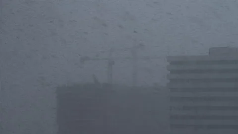 Time lapse. Working construction cranes during the heavy snowfall at winter Stock Footage 275290066