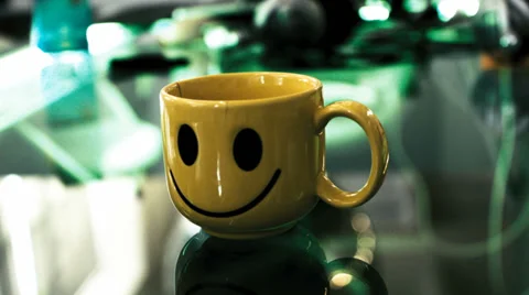 Time lapse of a yellow cup with smile in the office. Happy work-space concept Stock Footage 34530389