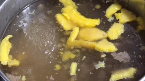 Time lapse of yellow fat dissolve in a liquid broth in a pot. Stock Footage 85718218