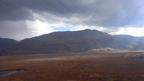 Time lapse of yellow grass distant mountains Stock Footage 293093609