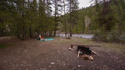 Time lapse of young couple setting up tent and starting a fire Stock Footage 79707524