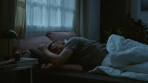 Time Lapse of Young Man Twisting in Bed in Restless Sleep at Night Stock Footage 314836803