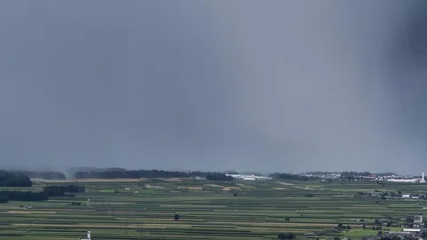 Time lapse zoom out rain storm over fields dark clouds gather Stock Footage 128698049