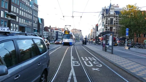 Time Lapse Zoom of Trams, Traffic &amp; People on a Busy Street in Amsterdam Stock Footage 59992918