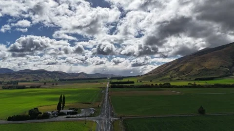 Time-lapse_Reverse Drone Flight Over New Zealand South Island Countryside Road Stock Footage 273289241