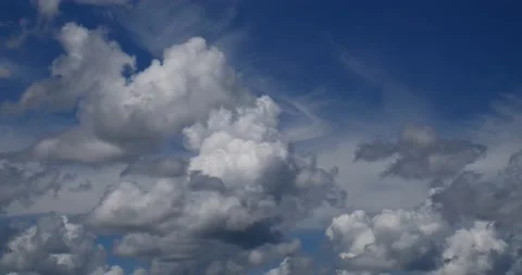 Time lapsed cumulus clouds build up to cumulonimbus storms under deep blue sky Stock Footage 152528581