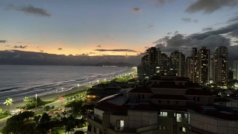 Time-Lapsed nightfall over beachfront avenue and clouds drifting  Stock Footage 332254913