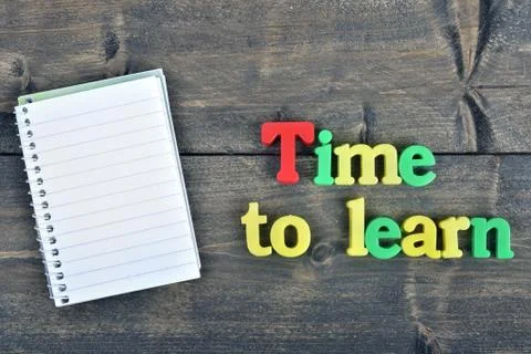 Time to learn on wooden table Photos