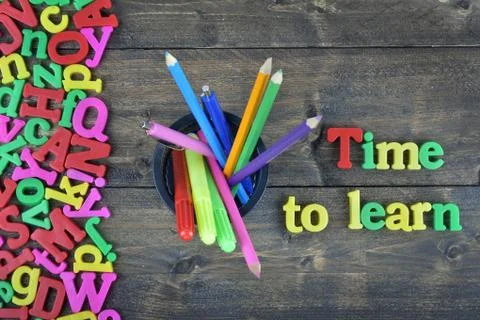 Time to learn on wooden table Photos