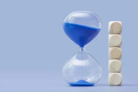 Time management and deadline concept with sand running through hourglass next Stock Photos