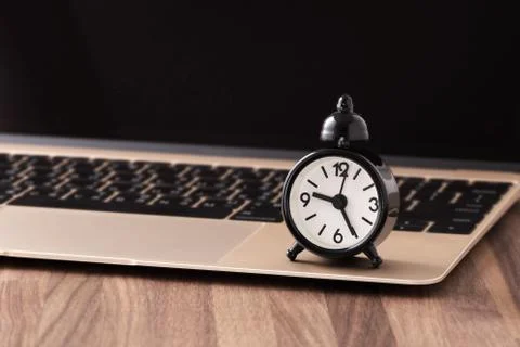 Time management concept with clock on computer Stock Photos