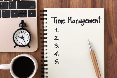Time management concept with computer, clock and list on notebook Stock Photos