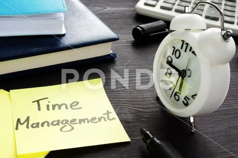 Time management written on a memo and alarm clock. Stock Photos
