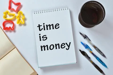 Time is money text on notepad Stock Photos