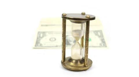 Time Is Money - White Sand Timer and Stack Of Cash_05A Stock Photos