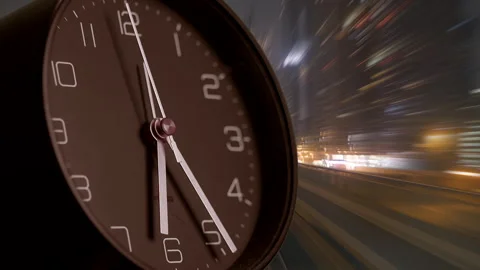 Time in Motion A Clock Set Against a Beautifully Blurred Urban Cityscape Stock Footage 293376499