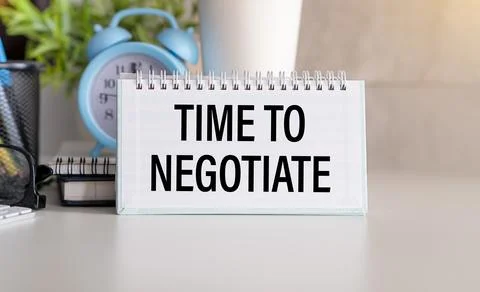Time to negotiate text on the notepad page on a white background Stock Photos