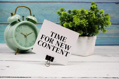 Time For New Content text written on paper card with alarm clock on wooden .. Stock Photos