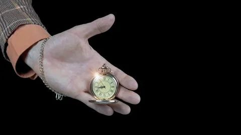 Time optimization concept. Male hand holding clock on dark background, close  Stock Photos
