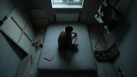 Time passing in creative space. Young artist lies, sits, writes, stares at Stock Footage 312328410