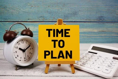 Time To Plan text written on paper card with calculator and alarm clock on .. Stock Photos