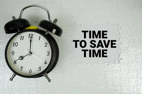 Time To Save Time text with alarm clock on white background Stock Photos