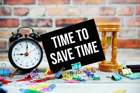 Time To Save Time text on paper card with alarm clock and stationary on woo.. 写真素材