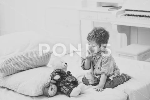 Time to sleep concept. Child in bedroom with silence gesture. Boy with happy Stock Photos