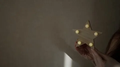 Time to sleep. Turn the star-shaped lamp on and off. Decorative lights hang. Glo Stock Footage 271063744